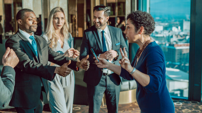 A woman leads a group discussion at an Insights Discovery workshop